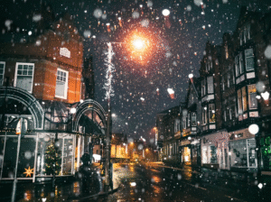 Snow falling on a residential street during winter at night